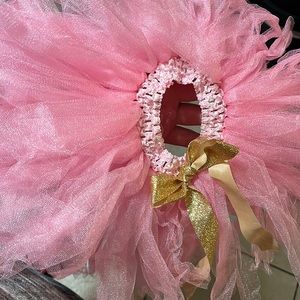 Never used pink baby tutu for 12 month old girl. It was homemade from Etsy.